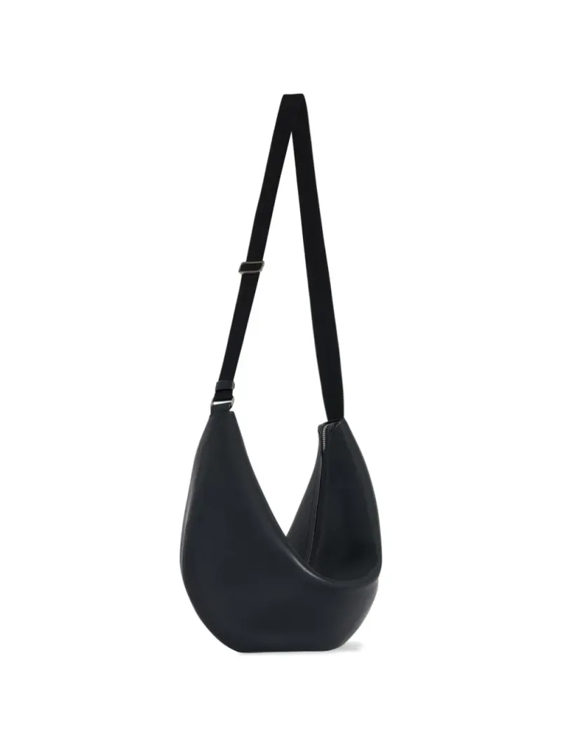 The Row crescent-shaped leather shoulder bag in Schwarz
